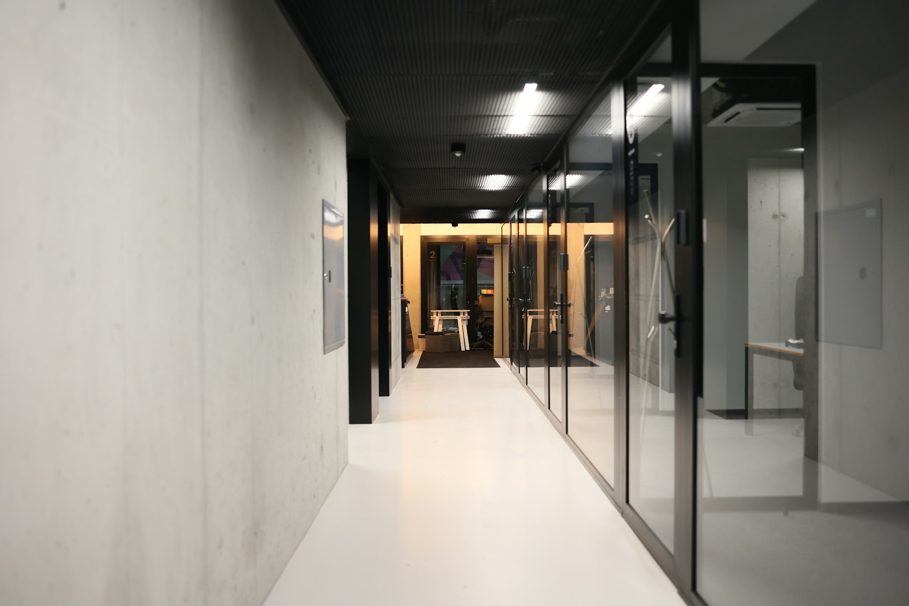 Modern office corridor with glass meeting rooms